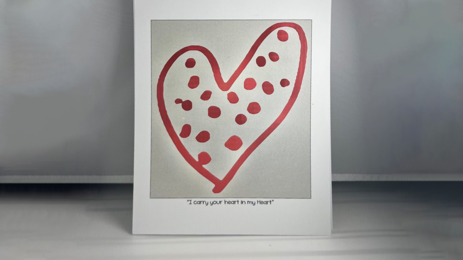 A red heart with red dots inside of it against a white background.